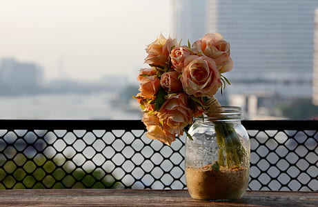 pink roses bouquet in clear glass mason jar close up photo thumbnail