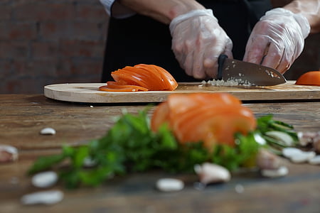 person slicing tomato on chopboard thumbnail