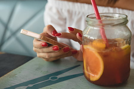 person holding rose gold SE beside jar on top of table thumbnail