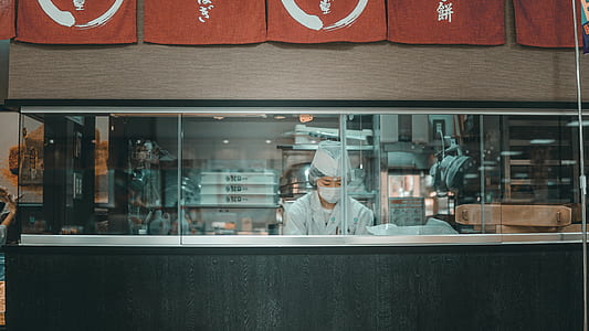 person wearing white inside store with glass windows and machines thumbnail
