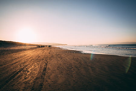brown sand on seashore at daytime thumbnail