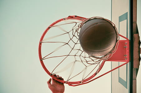 low angle photography of basketball on hoop thumbnail