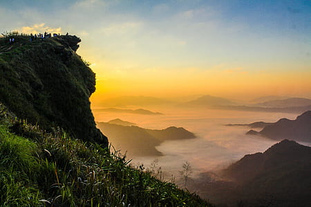Landscape Photography of Cliff With Sea of Clouds during Golden Hour thumbnail