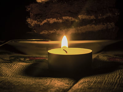 lighted tealight on brown fabric surface thumbnail