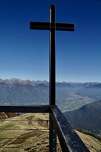black cross under blue sky at daytime thumbnail