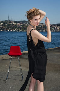 woman taking a pose beside shoreline thumbnail