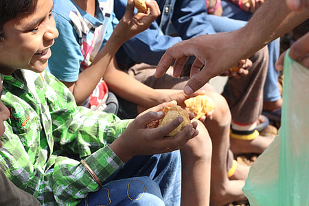 group of people sitting while holding bread thumbnail