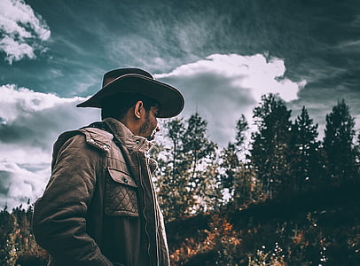 man wearing black cowboy hat standing thumbnail