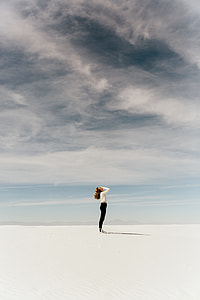 woman standing covering her face thumbnail