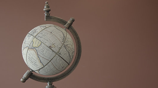 white desk globe on brown background thumbnail
