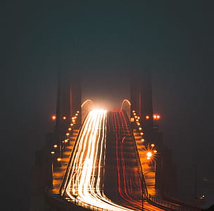 vehicle crossing bridge during nighttime thumbnail