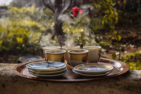 Brown Ceramic Teacups Beside Saucers on Brown Serving Plate thumbnail