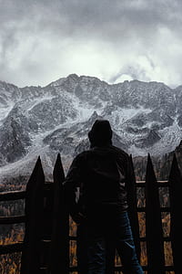 person standing near wooden fence thumbnail