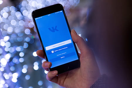 Person Holding Smartphone Displaying Vk Sign in Page thumbnail