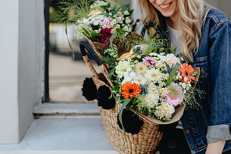 Young woman with basket full of flowers thumbnail
