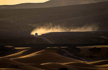 vehicle running on desert at dusk thumbnail