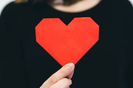 Hand Holding Origami Heart Photo thumbnail