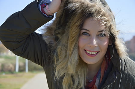 woman wearing parka coat smiling in front of camera thumbnail