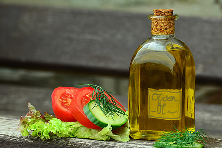 olive oil bottle and sliced tomatoes in shallow focus photography thumbnail