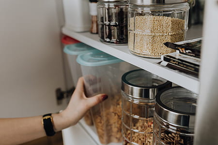 Containers of cereals in kitchen cupboard thumbnail