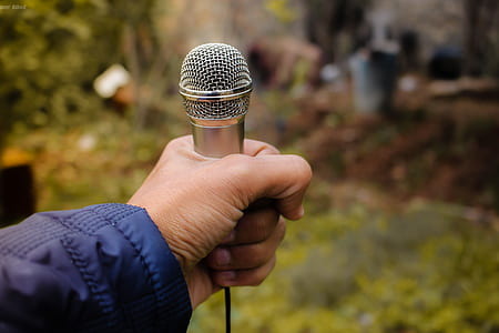 Person Holding Grey Corded Microphone in Selective Focus Photography Photo Taken thumbnail