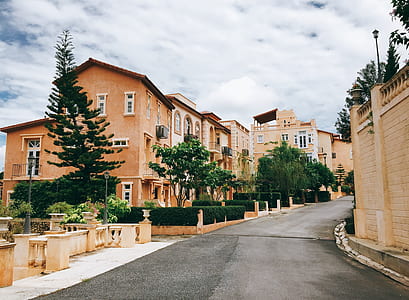 photo of brown buildings under cloudy sky thumbnail