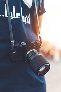 Close-up Photography of Person Wearing Black Point-and-shoot Camera thumbnail