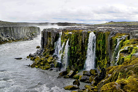 waterfalls surrounded by rock formation thumbnail