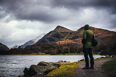 man standing beside a body of water thumbnail