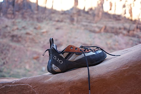 shallow focus photo of pair of black sneakers outdoor during daytime thumbnail