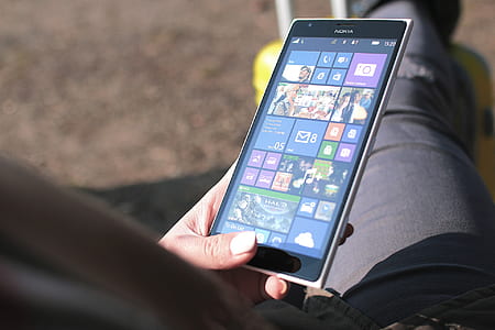 person holding black Nokia Windows phone thumbnail
