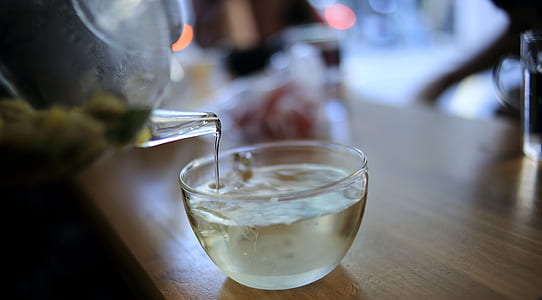 Clear Glass Pitcher Pouring Liquid on Clear Glass Cup thumbnail