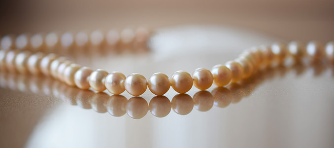 closeup photo of beaded brown pearl necklace thumbnail