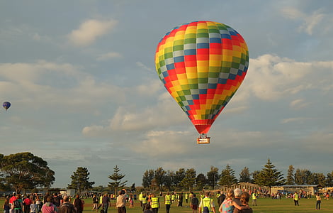 multicolored hot air balloon under cloudy sky at daytime thumbnail