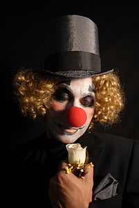 man wearing clown costume holding white rose thumbnail