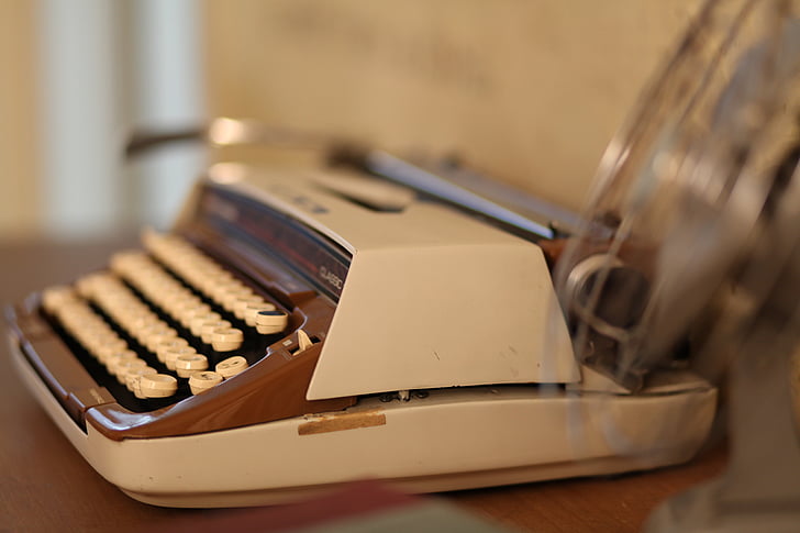 white and brown typewriter