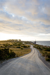 photo of rough road near body of water thumbnail