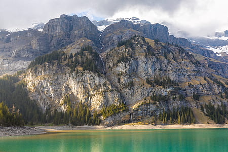 aerial photography of mountain beside water thumbnail