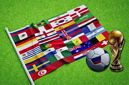 assorted flags near soccer ball and trophy thumbnail