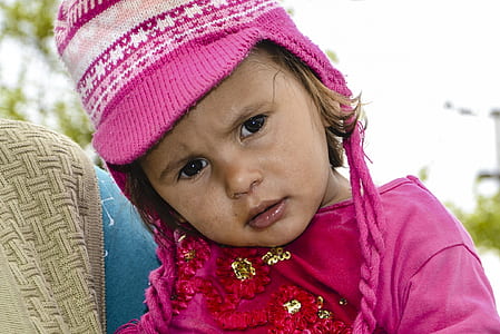 girl wearing knit cap and pink top thumbnail