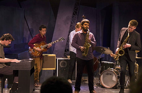 five men playing instrument inside room thumbnail