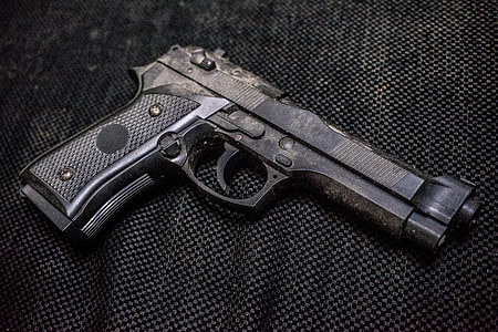 black semi-automatic pistol on black textile thumbnail