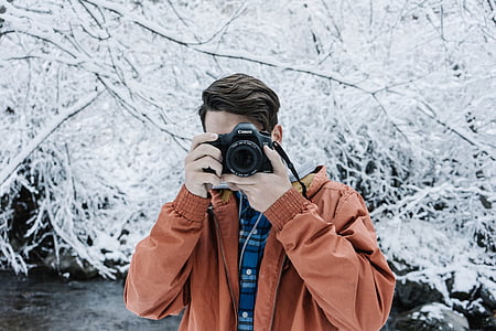 man taking photo with white leafed tree background thumbnail