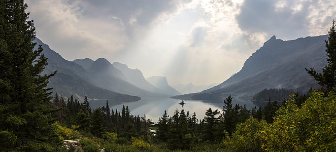 Sunlight from above the clouds over the lake at Glacier National Park, Montana thumbnail
