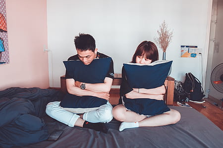 Man and Woman Sitting on Bed thumbnail