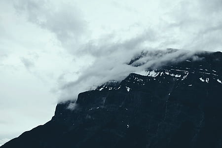 mountain under cloudy sky during daytime thumbnail