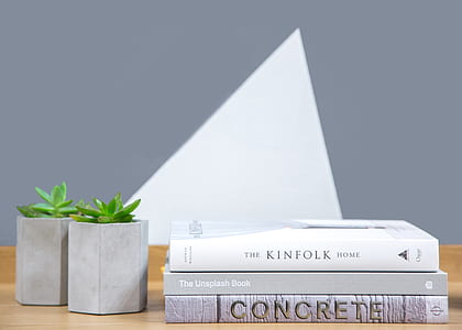 three assorted-title books on brown wooden surface thumbnail