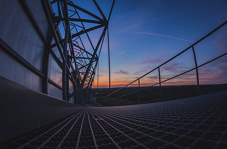 wide angle photography of metal platform under golden hour thumbnail