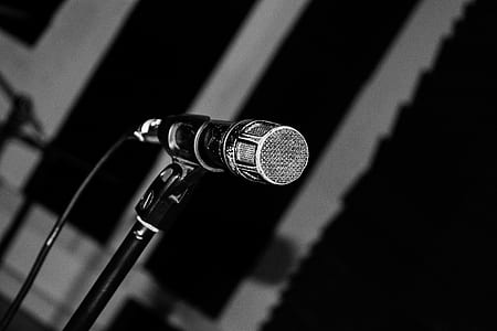 black and gray corded microphone with stand in grayscale photography thumbnail