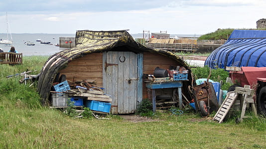 brown shed near body of water thumbnail